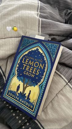 the lemon trees grow book is laying on some blankets