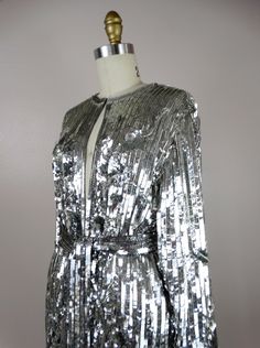 "This is another AMAZING vintage piece! It's fully embellished with eye-catching reflective sequins and is in perfect condition! Measurements: Bust - 40\" Shoulders - 16\" Sleeves - 21\" Top to Bottom - 31\" All of my items come from a smoke-free and pet-free home. If you have any questions, please don't hesitate to ask!" Glamorous Embellished Outerwear For Party, Glamorous Embellished Party Outerwear, Luxury Silver Outerwear For Parties, Glamorous Sequined Evening Outerwear, Glamorous Sequin Outerwear For Evening, Glamorous Embellished Outerwear For Festive Occasions, Festive Glamorous Sequin Outerwear, Luxury Metallic Party Outerwear, Silver Sequined Outerwear For Evening