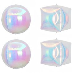 three white balloons with iridescent designs on them