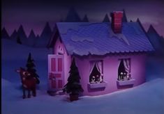 there is a pink house in the snow with two people standing outside and one person on a horse