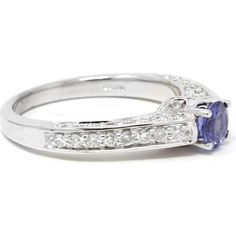 Experience a cascade of charm with the ethereal allure of our 14K White Gold Tanzanite Fashion Ring. Crafted to captivate, this mesmerizing piece features a luminous tanzanite center stone, weighing in at .43 carats, embraced by a halo of shimmering diamonds totaling .60 carats. Set in the elegance of 14K white gold, every angle of this ring exudes sophistication and grace, making it the perfect statement piece for any occasion. Whether worn as a symbol of individuality or as a dazzling addition to an ensemble, this ring is sure to enchant and inspire.Details: Exquisite Estate Jewelry: Handpicked from history, this pre-owned piece is a treasure of extraordinary rarity and charm. This unique, one-of-a-kind find encapsulates the luxury and timeless elegance that only high-end estate jewelry Elegant Tanzanite Gemstones With Halo Setting, Fine Jewelry Tanzanite Halo Ring, Elegant Tanzanite Halo Ring, Luxury Tanzanite Halo Jewelry, Exquisite White Gold Tanzanite Ring, Enchanted, Estate Jewelry, Timeless Elegance, Fashion Rings