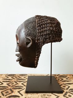 A One-of-a-Kind, handcarved Mwana Pwo Chokwe  mask handmade by artist in Angola. This mask resembles a human with slit eyes, a sharp nose and broad lips. The face features traditional scarification marks on the forehead and cheeks as symbols of beautification. The hair, one of the most dramatic features, is woven and m Sharp Nose, Afrocentric Style, Wood Mask, Face Features, Male Dancer, African Mask, African Decor, African Masks