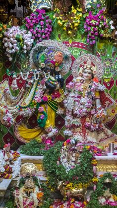 an idol is displayed in front of flowers