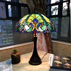 a stained glass lamp sitting on top of a table