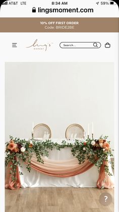 the wedding table is decorated with flowers and greenery