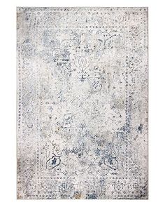 an old rug with faded blue and white colors on the bottom, in front of a white background