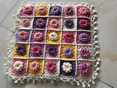 a crocheted square with flowers on it