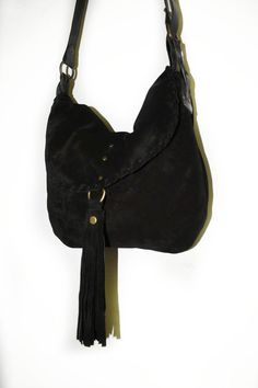 Crossbody bag made with soft black suede and stronger brown leather. This bag has a soft structure and a very strong shoulder strap made with high quality leather. The bag is a medium size messenger with a slightly rounded shape and a soft structure, the flap is embellished by a suede seam and a beautiful suede tassel. The shoulder strap width is 0.8 inch. The shoulder bag is adjustable with a beautiful buckle. The bag is unlined and there aren't pockets inside. Features : - Black suede, - Black Suede Soft Leather Hobo Shoulder Bag, Suede Soft Leather Hobo Bag, Soft Leather Suede Hobo Bag, Leather Shoulder Bag With Suede Lining, Suede Hobo Bag With Leather Handles, Suede Lined Hobo Shoulder Bag, Soft Leather Suede Satchel Shoulder Bag, Black Leather Bag With Suede Lining, Travel Suede Hobo Bag With Soft Leather