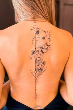 the back of a woman's neck with an arrow and lions on it