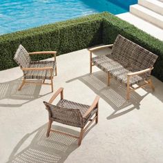 an outdoor seating area next to a swimming pool