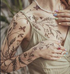 a woman with tattoos on her arms and chest