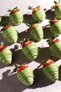 chocolate covered strawberries are arranged in the shape of strawberrys with green icing