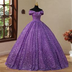 Off Shoulder Sequined Purple Quinceanera Dress Make a statement at your next special occasion with this stunning Off Shoulder Sequined Purple Quinceanera Dress. The intricate sequin detailing adds a touch of glamour and sparkle, while the V-neckline and short sleeves create a flattering and elegant look. The floor-length design exudes sophistication and the ball gown silhouette adds a touch of vintage charm. This dress is perfect for all ages and is customizable to ensure the perfect fit. Whethe Ball Gown Vintage, Purple Quinceanera, Ball Gowns Vintage, Quinceanera Dresses Black, Prom Dress Ball Gown, Purple Quinceanera Dresses, Romantic Dresses, Gown Fashion, Gown Vintage