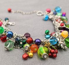 "- Old Fashioned Christmas Charm Bracelet Chain is adjustable from 7\" - 9\" with a lobster claw closure and extension chain The bracelet links are filled with a rainbow of glass and gem stone beads and crystals - really pretty. Mixed between the beads and gemstones are vintage Christmas themed charms and tiny jingle bells. This makes a great gift or the perfect holiday accessory for yourself! Your bracelet will be carefully gift packaged and shipped via USPS First Class Mail. Feel free to conta Multicolor Dangle Jewelry With Lobster Clasp, Nickel-free Rainbow Jewelry For Party, Colorful Metal Jewelry For Gifts, Colorful Metal Jewelry Gift, Colorful Metal Jewelry As A Gift, Colorful Metal Jewelry As Gift, Colorful Costume Jewelry Gift, Bohemian Jewelry For Christmas Holiday, Bohemian Jewelry For Christmas