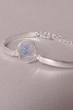 Blue Forget me not bracelet Pressed flower jewelry Real flower bracelet Bridesmaid Gift Remembrance Gift Natural Botanical #NewJewelleryStory Bracelet length: 8 Inches; Bracelet width: 1/2 InchesBlue Forget me not flower in resin bracelet . Pressed flower jewelry .#bracelet #Pressed #flower #jewelry Blue Resin Bracelets For Gift, Blue Resin Bracelets As Gifts, Blue Resin Bracelets Perfect For Gifts, Blue Resin Bracelets For Gifts, Resin Bangle Jewelry For Gifts, Resin Bangle Jewelry Gift, Silver Birth Flower Bracelet Jewelry, Pressed Flower Bracelet Jewelry For Gift, Pressed Flowers Bracelet Jewelry Gift