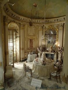 an elaborately decorated dining room with chandelier and table cloths on it