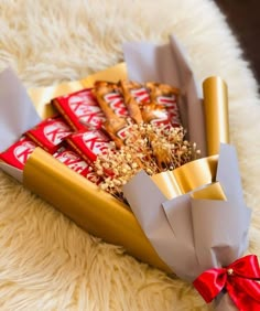 a tray filled with assorted candy bars on top of a white rug