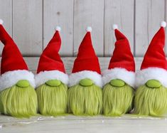 six green hair elves with red hats on them are lined up in a row,