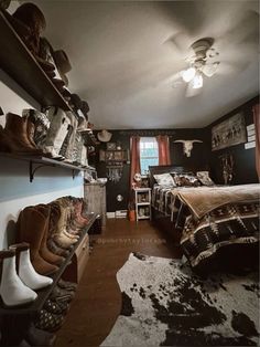 a bedroom with cowboy themed decor and cow hide rugs