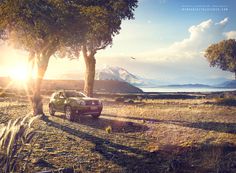 a car parked on the side of a dirt road next to some trees and mountains