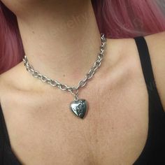 Stunning gothic/punk style chunky broken heart choker necklace in silver 💔  Chunky yet lightweight and comfortable to wear this necklace goes well with any outfit! This necklace is made of 100% stainless Steel so is water resistant and won't tarnish or discolour! Available in various sizes ( necklace shown in photographs measures 15 inches) Width of chain: 12mm Heart pendant measures: 29x26mm Please don't hesitate to contact me with any queries or suggestions 😊  Comes gift wrapped 🖤 Gothic Heart-shaped Choker For Valentine's Day, Gothic Heart Choker For Valentine's Day, Edgy Heart-shaped Choker For Concerts, Grunge Metal Necklaces For Valentine's Day, Punk Style Heart Necklace For Gift, Silver Heart Necklace In Grunge Style, Punk Metal Heart Necklace For Valentine's Day, Punk Style Metal Heart Necklace For Valentine's Day, Gothic Metal Heart Necklace For Valentine's Day