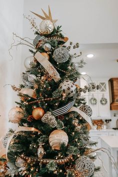 a christmas tree decorated with gold and silver ornaments