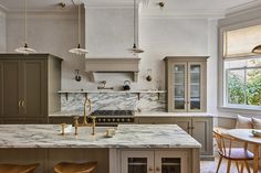 a kitchen with marble counter tops and wooden stools