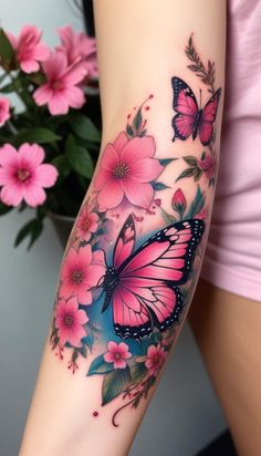 a woman's arm with pink flowers and butterflies on it