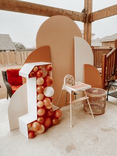 an outdoor area with furniture and balloons on the ground