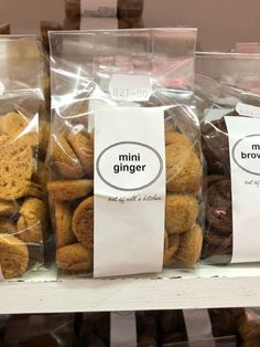 three bags of mini ginger cookies sitting on top of a shelf next to each other