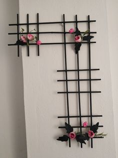 the wall is decorated with black and pink flowers, which are attached to metal bars