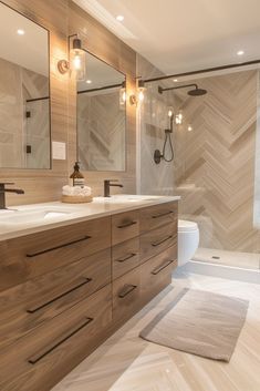 a modern bathroom with wooden cabinets and marble counter tops, along with a walk in shower