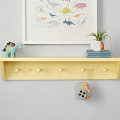 Add a pop of color and brilliant organization to your little one's wall with this vibrant shelf. Crafted of solid wood, it offers five pegs for hanging coats and backpacks, plus a shelf for grab-and-go items. KEY PRODUCT POINTS Handcrafted from solid poplar wood and finished with acrylic latex paint in a variety of vibrant colors (each sold separately). Pegs are made from 100% birch wood. BPA-, Phthalate- and Lead-free. Mounting hardware is included. Domestic.