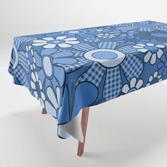 a blue table cloth with flowers and circles on it, set against a white background