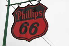 a red and black sign that reads phillips's 66