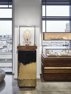 a display case in the middle of a room filled with jewelry