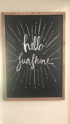 a chalkboard with the words hello sunshine written on it in white paint and wood frame