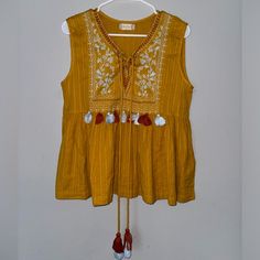 Embroidered Altar’d State Mustard Yellow Tank Top With Tassels. Bohemian Chic Look. Very Cute Detailing And Stylish For Spring And Summer! Never Worn, Like New Material. Size Medium And True To Size. In Perfect Condition! Cotton Tassel Tops For Festivals, Festival Cotton Blouse With Tassels, Cotton Festival Blouse With Tassels, Yellow Bohemian Tops For Festive Occasions, Spring Cotton Embroidered Top With Tassels, Cotton Tops With Tassels For Vacation, Festive Bohemian Yellow Tops, Bohemian Sleeveless Top With Tassel Ties, Sleeveless Tops With Tassel Ties For Spring