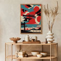 a table with bowls and vases on it in front of a poster that says tokyo