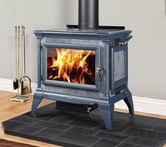 a stove that is sitting in the middle of a room with a rug on it