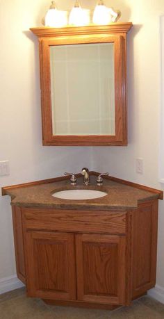 a bathroom with a sink, mirror and window in the corner on the wall above it