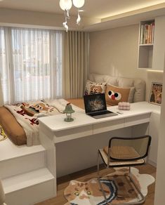 a desk with a laptop on top of it next to a chair and bookshelf