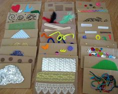 cardboard boxes filled with crafting supplies on top of a wooden floor