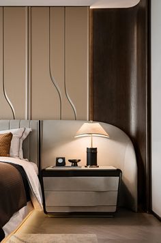 a bedroom with a bed, night stand and lamps on either side of the bed