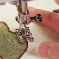 someone using a sewing machine to sew a heart