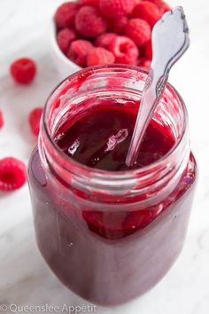 raspberry jam in a jar with a spoon