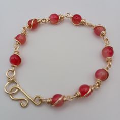 These bracelets feature a combination of brilliant red beads, wrapped in gold wire. The beads are evenly spaced and secured with a decorative wire-wrapping technique. The closure is a handmade hook clasp, also in gold enamel copper based wire, which adds a unique handmade touch. The beads are wrapped in gold enamel copper base wire in a consistent style, giving it a cohesive and elegant look. Wire Wrapping Techniques, Enameled Copper, Red Beads, Palm Beach Fl, Hook Clasp, Red Bead, Gold Wire, Gold Enamel, West Palm Beach