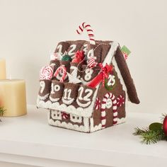 a gingerbread house is decorated with candy canes and candies for the holiday season