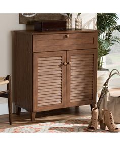 a wooden cabinet sitting on top of a rug