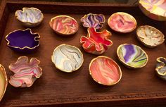 a wooden tray topped with lots of different colored dishes